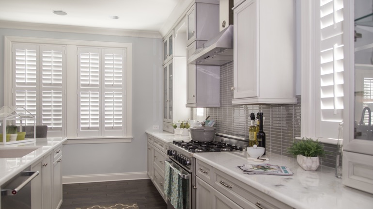 Plantation shutters in Detroit kitchen with white cabinets.